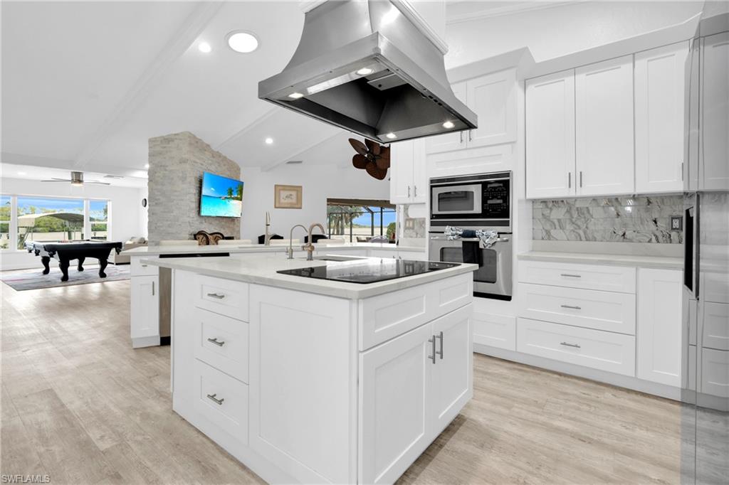 The Fully Equipped Island Kitchen Comes With Upgraded White Wood Cabinets & Drawers, Quartz Countertops, Tile Backsplash, Stainless Steel Appliance With Stainless Steel Hood, Wall Oven, Microwave, Stainless Steel Sink, Bosch Instant Under The Sink Hot Water Heaters, And A Multi-Person Breakfast Bar!