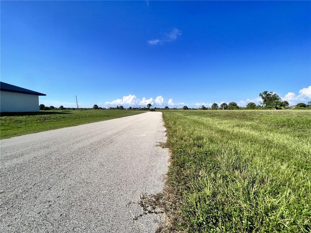 View of asphalt road with a rural view