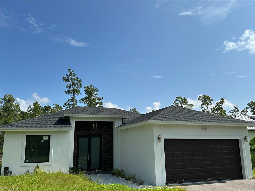 Contemporary stucco exterior with a dark shingle roof