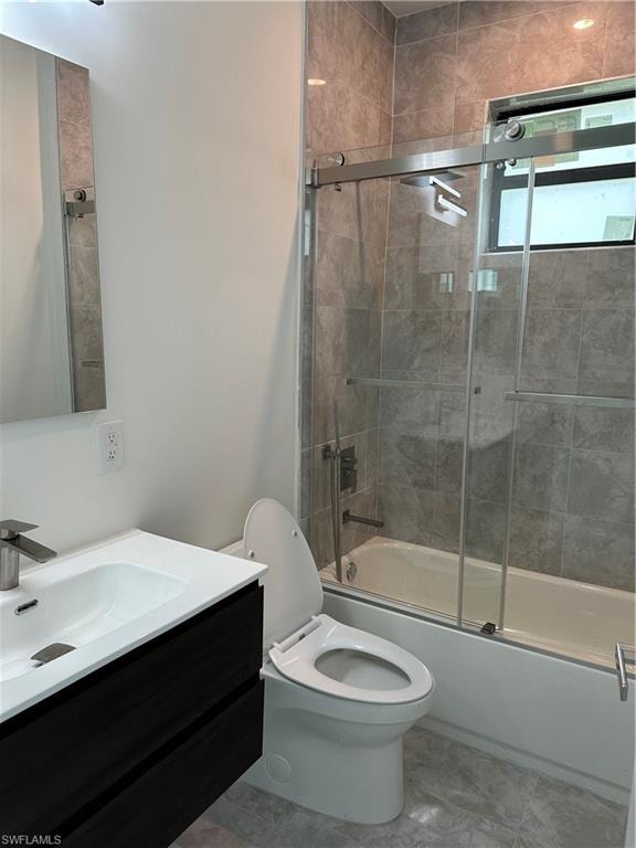 Modern bathroom featuring a dark wood-finish floating vanity with an integrated sink, brushed nickel faucet, a frameless wall mirror, and a toilet
