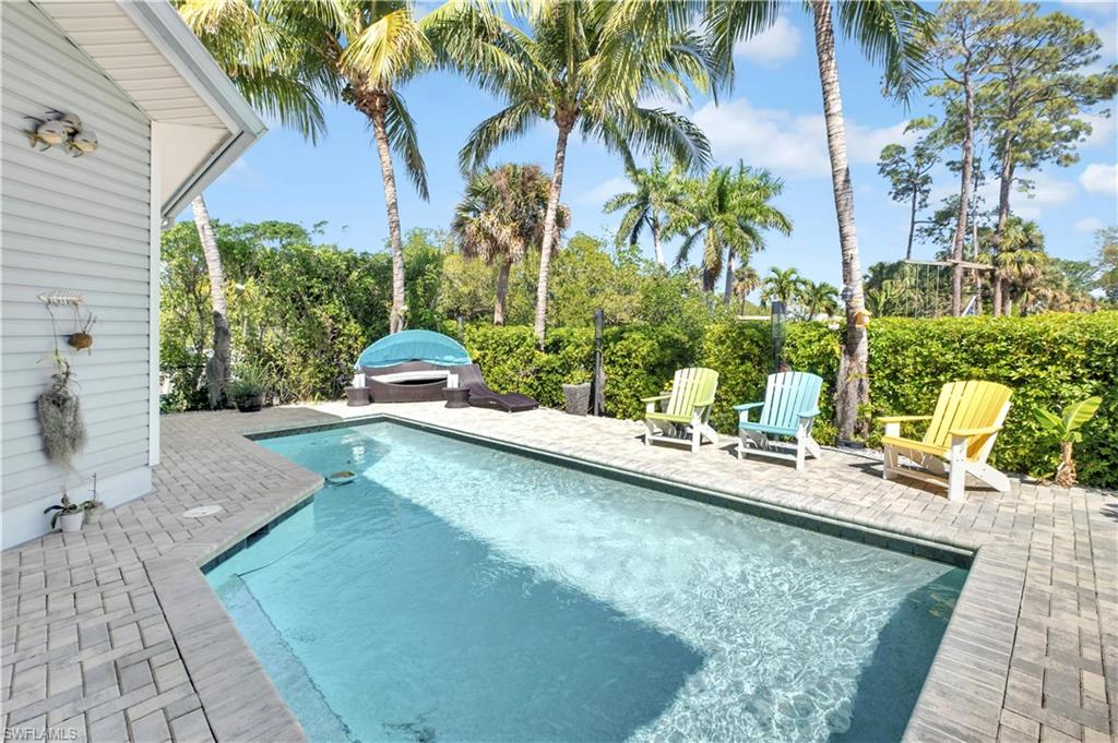 Rectangular swimming pool with integrated steps, surrounded by paver decking