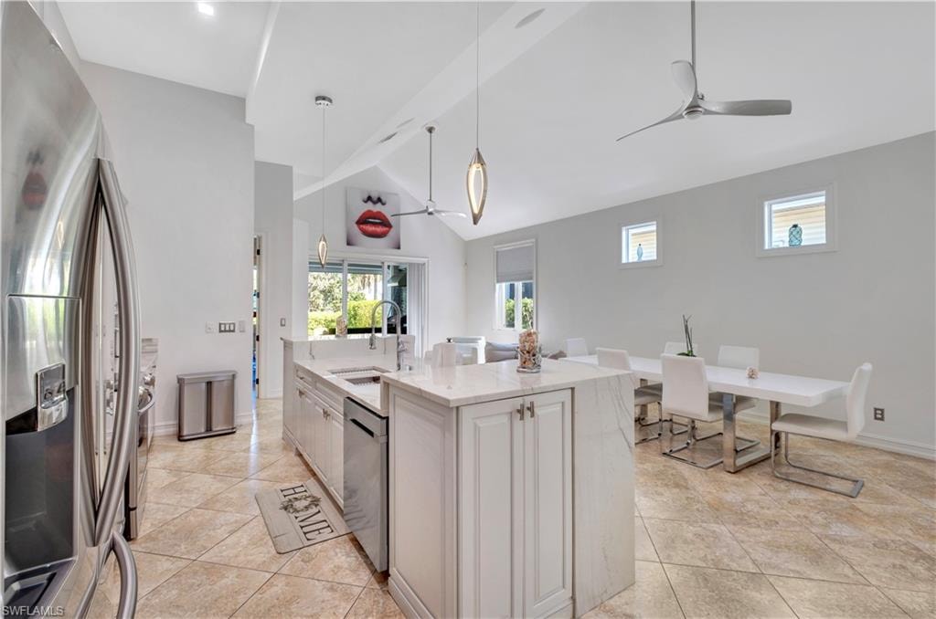 Kitchen with vaulted ceilings, recessed lighting, and tile flooring