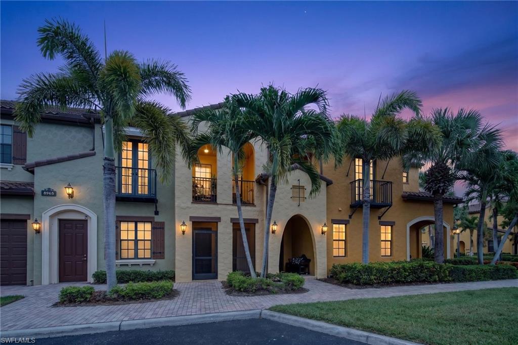 Mediterranean-inspired exterior with stucco finish and barrel tile roofing