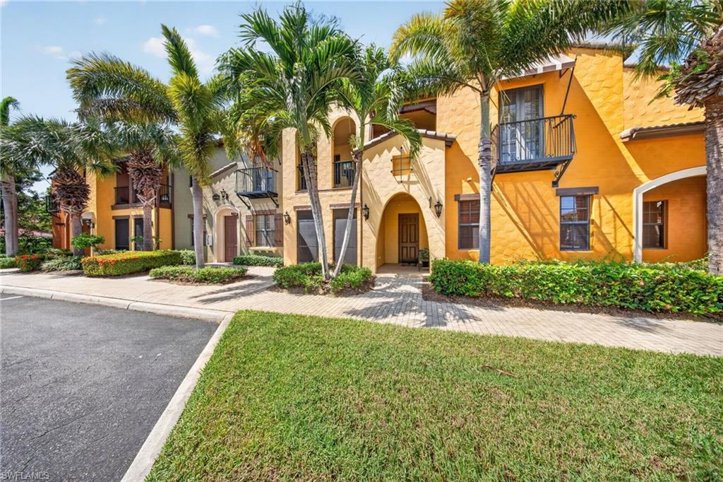 Mediterranean-style multi-story architecture with textured stucco exterior and tile roofing
