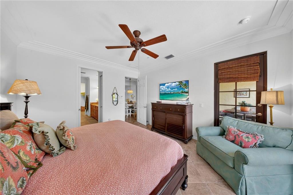 Spacious room featuring neutral wall tones, crown molding, and tile flooring