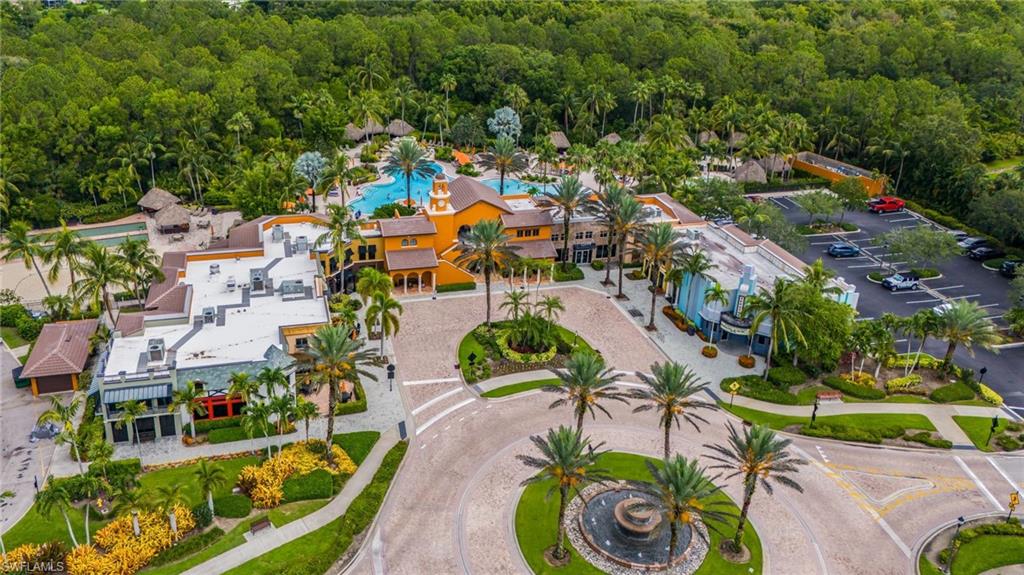Community amenities featuring a large resort-style swimming pool, multiple buildings with varied architectural styles, and mature landscaping
