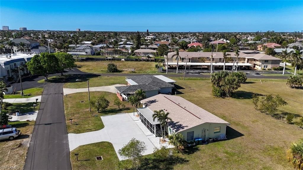 Single-story property with a light-colored shingle roof and an attached screened patio