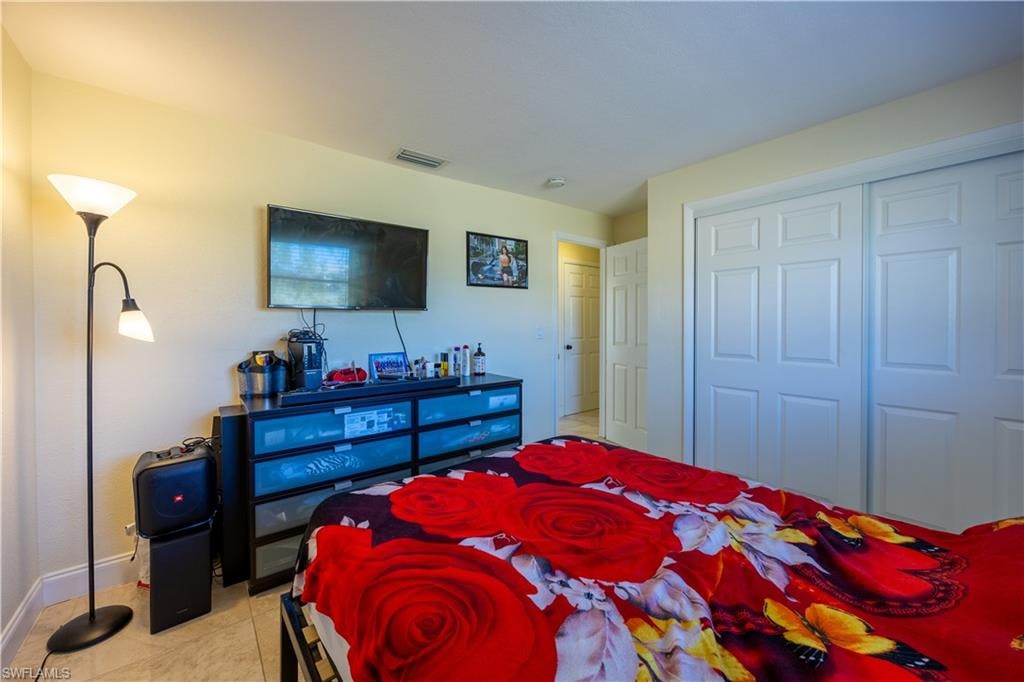 Room featuring light-toned wall paint and tile flooring