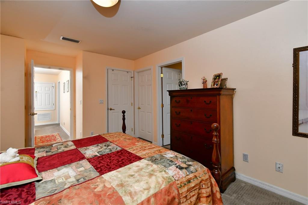 Carpeted bedroom with a cream wall color and white trim