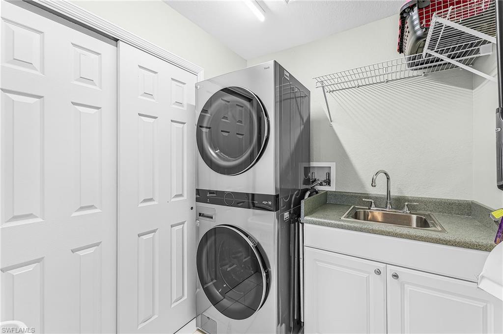 The upstairs laundry features extra storage closet, utility sink, til floors, full size washer and dryer.