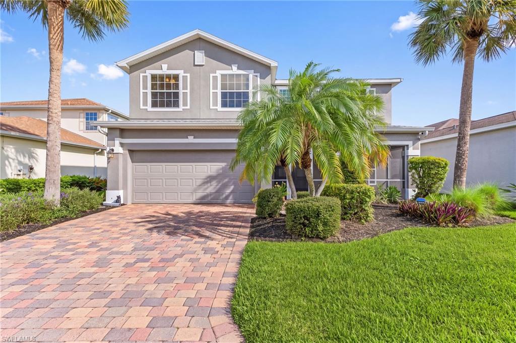 Welcoming entry to this home. Brick paver driveway, screened front entry, nice landscaping.