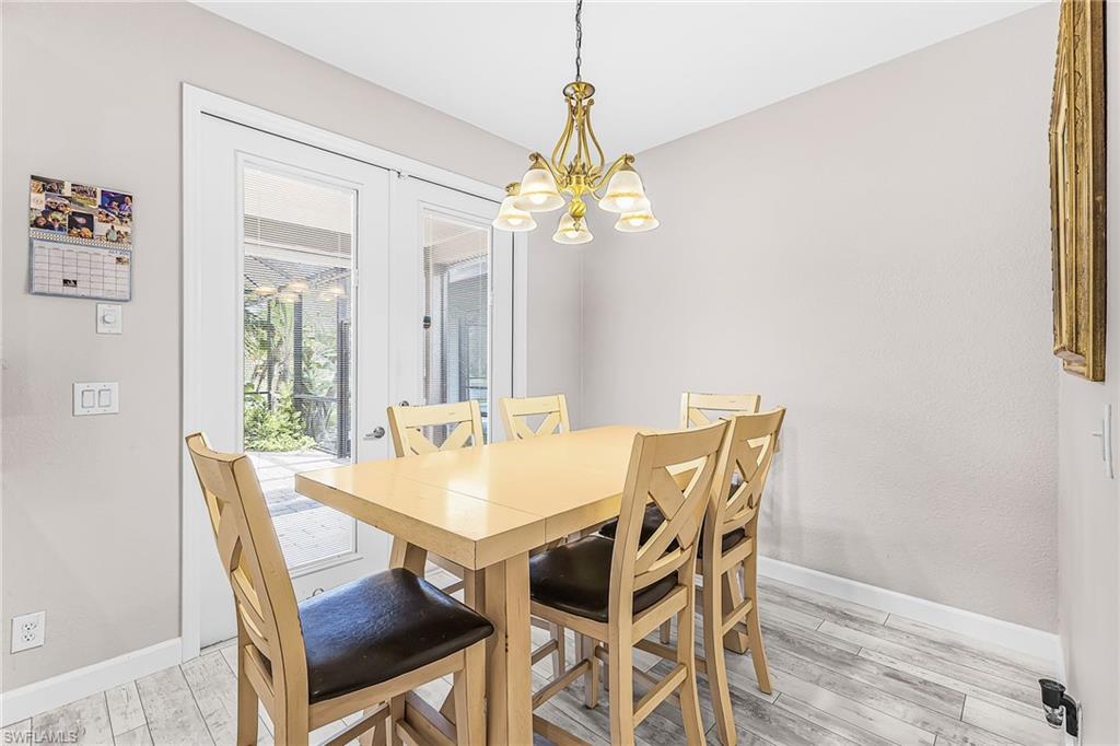 Dining area has French doors out to the screened lanai.
