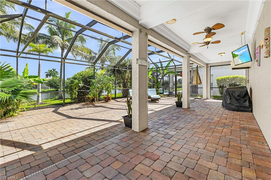 The extended brick paver patio has an expansive lake view, new screens, grilling area, planters.