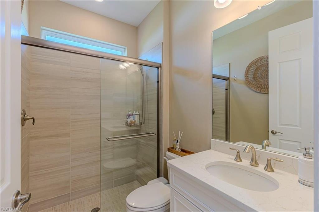 Full bath featuring vanity and a shower stall
