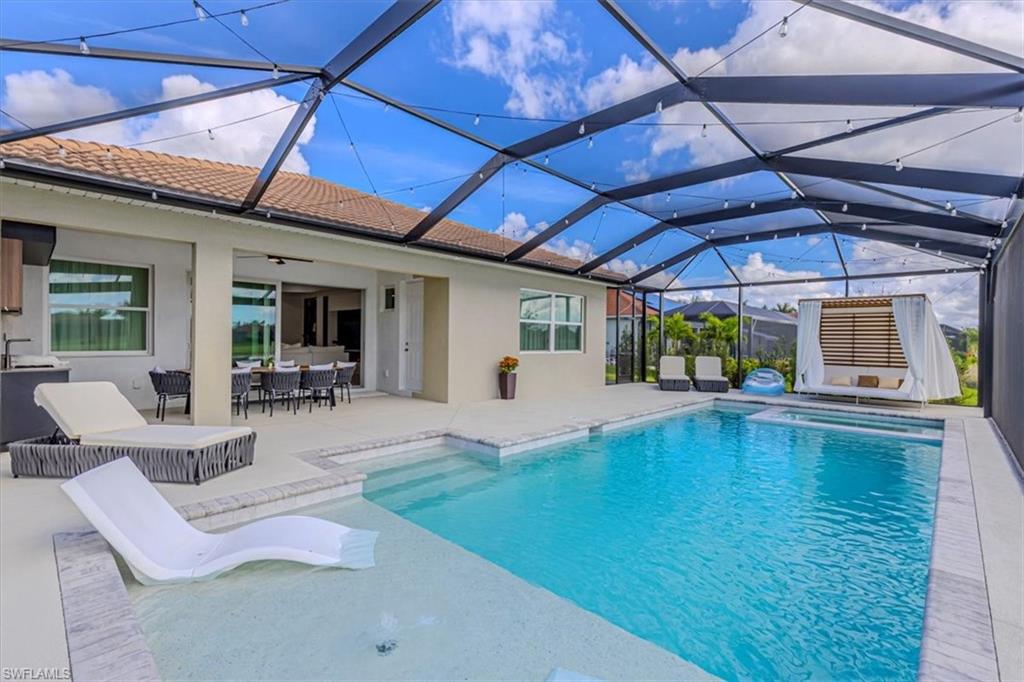View of pool with a patio, a lanai, a sunroom, and outdoor dining space