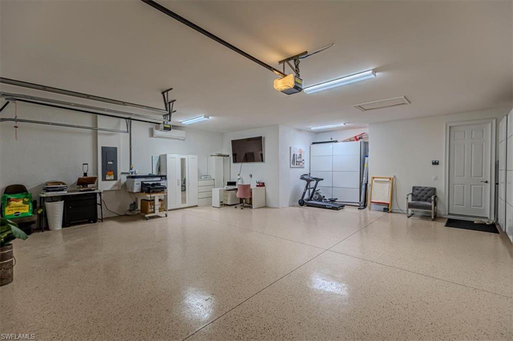 Garage with electric panel and a garage door opener