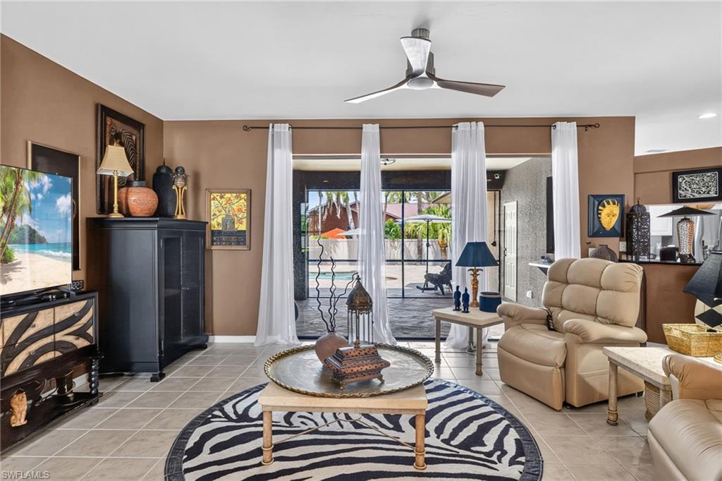 Living area with neutral tile flooring and direct access to the outdoor area
