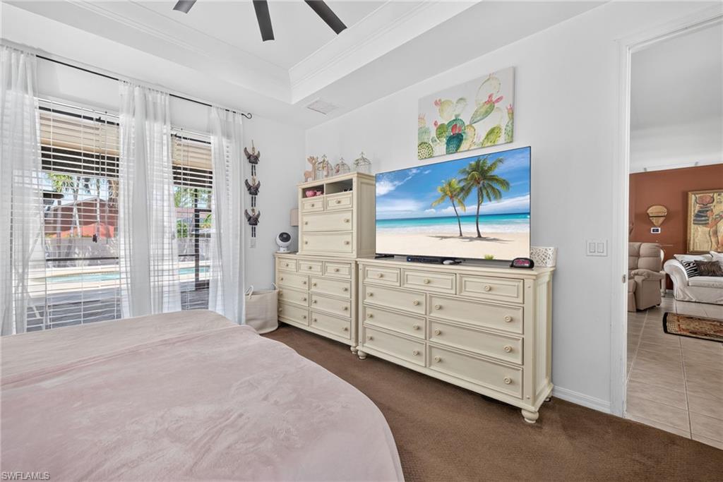 Room featuring multiple windows with blinds, offering a view of the outdoor pool area