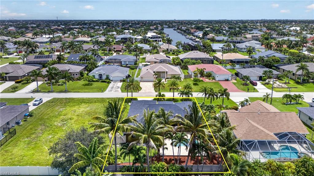 Single-story property with mature palm trees and established landscaping