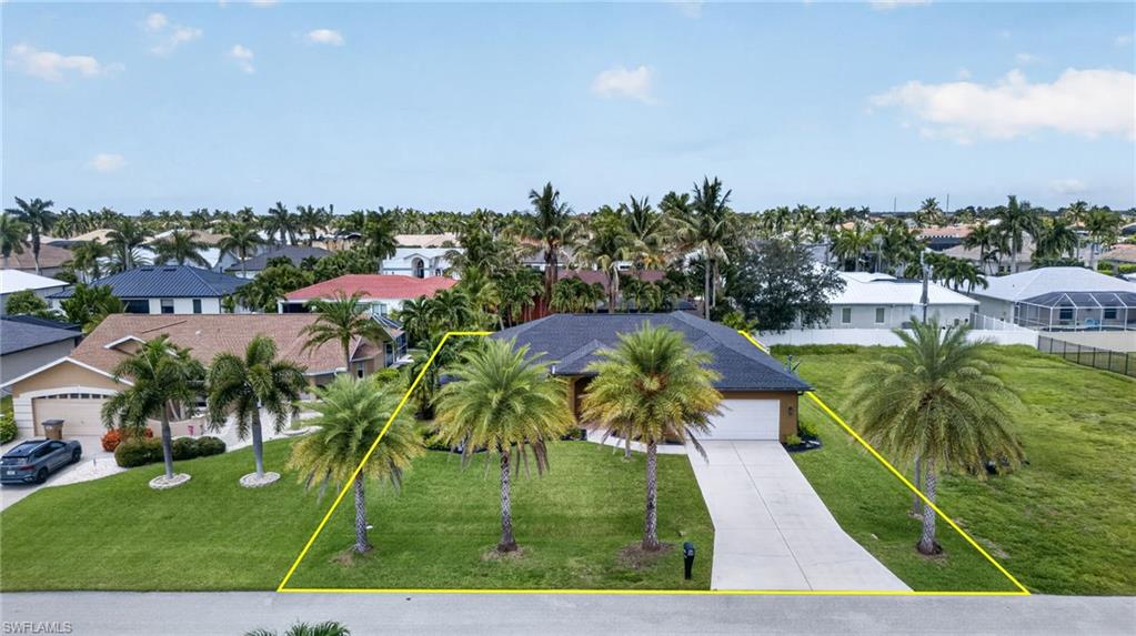 Single-story residence featuring a dark shingle roof, attached two-car garage, and a concrete driveway