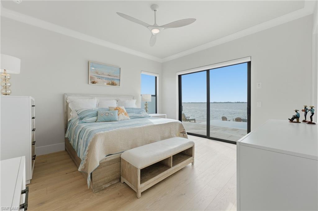 The fourth bedroom offers a private retreat with direct access to the expansive lanai and shimmering infinity pool, while captivating water views create a serene backdrop. Thoughtfully designed for both comfort and privacy, this elegant suite provides an exceptional connection to the waterfront lifestyle.