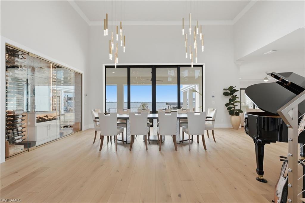 As you enter this extraordinary masterpiece, your gaze is immediately drawn beyond the soaring interiors to the breathtaking water views. European white oak flooring flows throughout, while a temperature-controlled 300-bottle wine gallery awaits, offering the perfect selection to savor as you dine and entertain against an unforgettable waterfront backdrop.