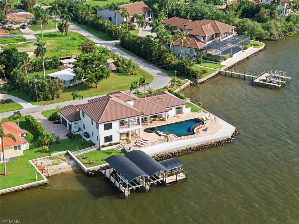 Set across two private homesites, this extraordinary waterfront estate offers a rare sense of seclusion and privacy, framed by unobstructed views of Southwest Florida’s spectacular sunsets. Each evening, the sky becomes a breathtaking masterpiece, creating an unparalleled backdrop for refined waterfront living.
