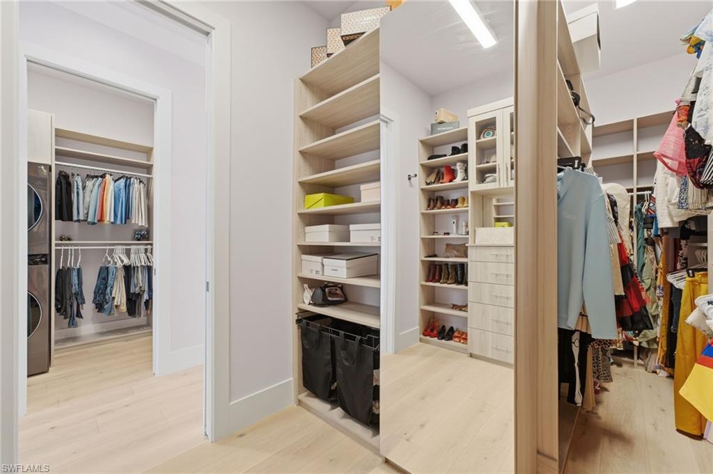 The second-level primary suite is complemented by expansive walk-in closets and the exceptional convenience of a full-size, stacked washer and dryer, creating a private retreat that combines refined luxury with effortless everyday living.