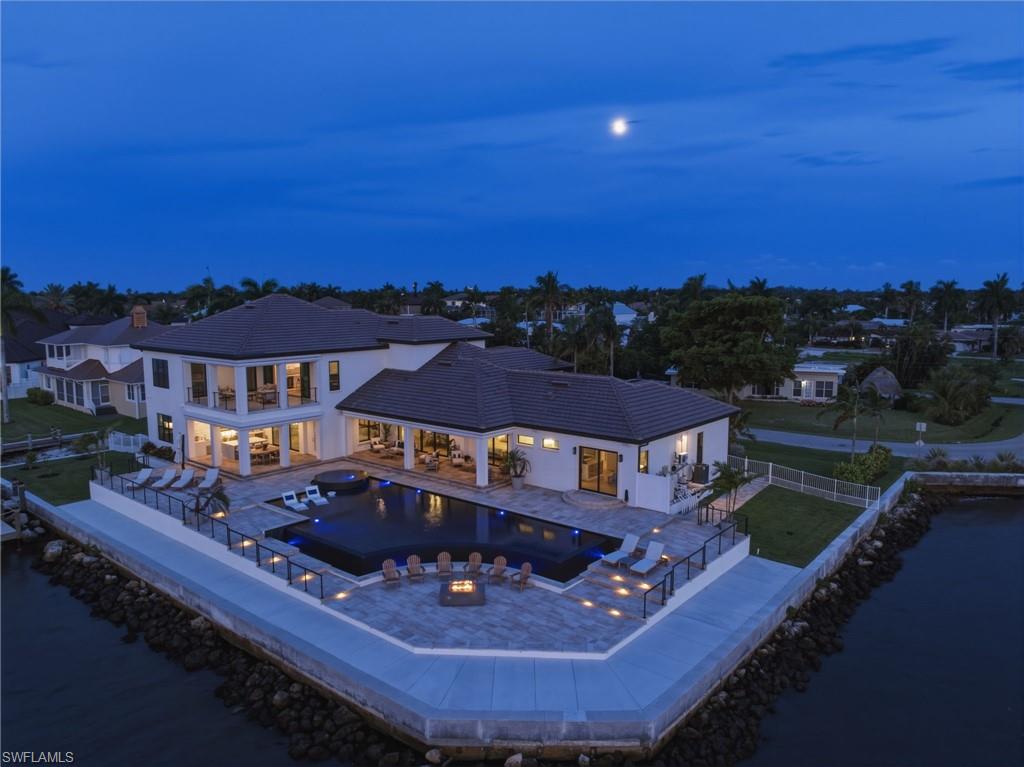 More than 8,100 square feet of beautifully pavered outdoor living space unfolds around the estate, complemented by an expansive wraparound captain’s walk that enhances both waterfront access and the exceptional scale of this private coastal retreat.