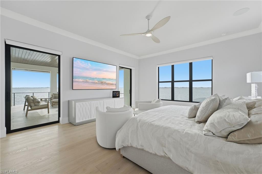 The luxurious primary suite is privately positioned on the second level, where two expansive pocketing glass sliders open effortlessly onto an oversized private balcony. Step outside to breathtaking, unobstructed waterfront views, creating an extraordinary retreat to savor the beauty of Southwest Florida.