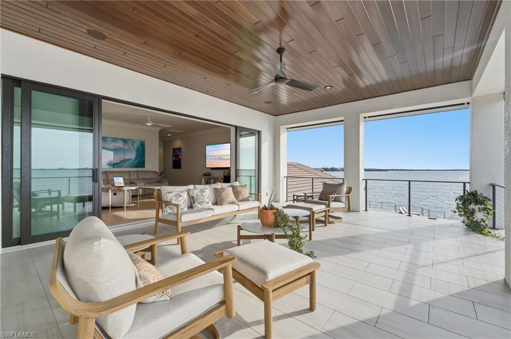 This private balcony is conveniently accessed from both the primary suite and the upstairs living room, offering a seamless transition to the breathtaking waterfront setting.