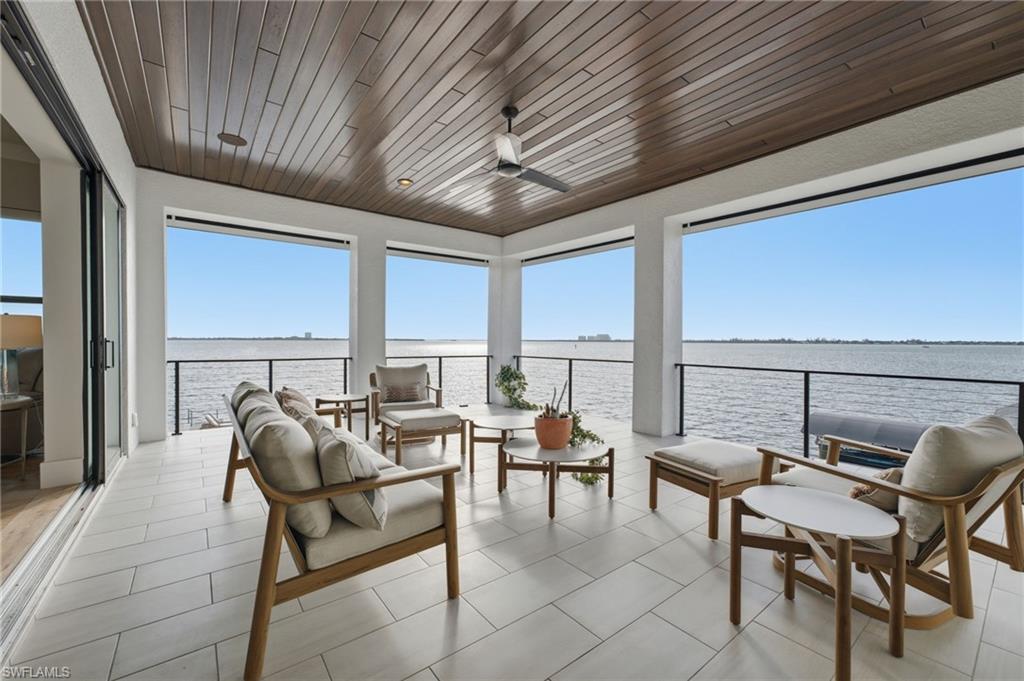 The private balcony offers unobstructed river views, complemented by hurricane screens for added protection and a beautifully appointed tongue-and-groove ceiling, creating an elegant outdoor retreat for year-round enjoyment.