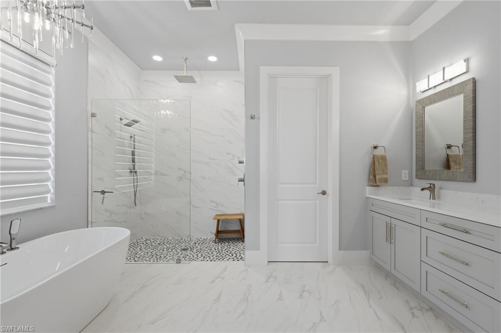 The fifth bedroom’s luxurious ensuite bath mirrors the sophistication of the second-level primary suite, featuring dual vanities, an expansive walk-in shower, and a separate soaking tub. Every detail is thoughtfully designed to create a private, spa-inspired retreat for ultimate comfort and relaxation.