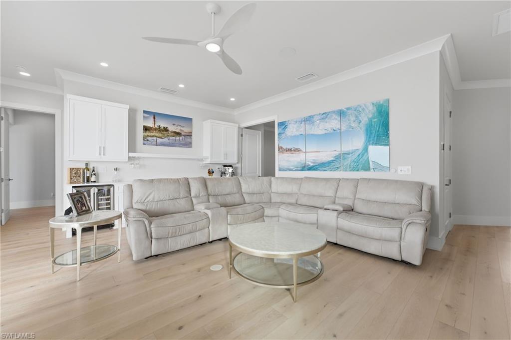 The second-level living lounge offers an elevated retreat, complete with a quartz breakfast bar, refrigerator, and dedicated wine cooler area. Designed for relaxed entertaining, this sophisticated space opens to sweeping waterfront views.