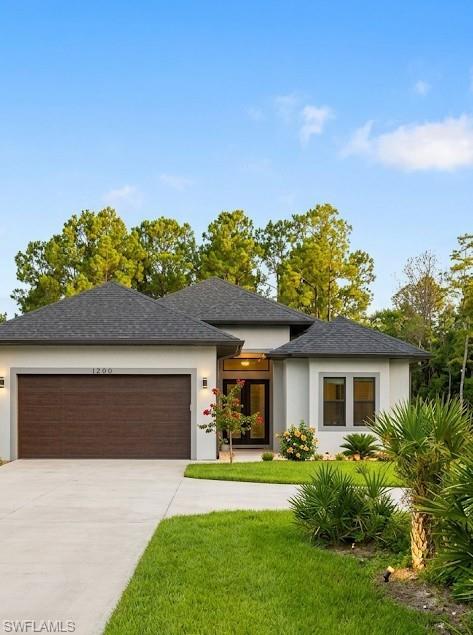 Contemporary stucco exterior with a dark wood-finish garage door, prominent front entry, and varied rooflines