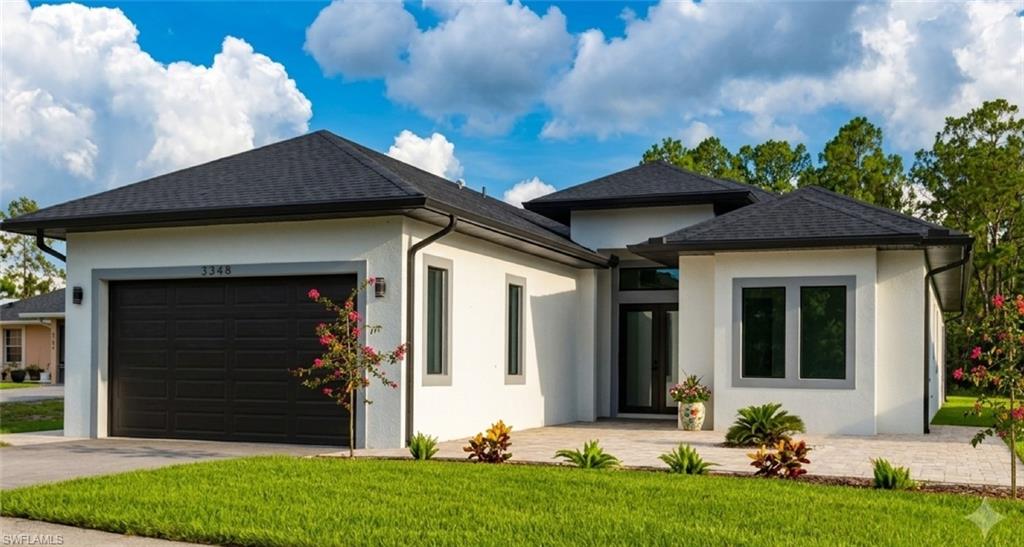 Contemporary exterior with a dark asphalt shingle roof and white stucco finish