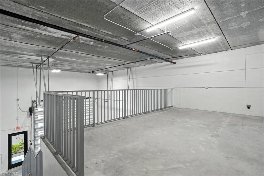 Mezzanine level featuring a concrete floor and exposed concrete ceiling