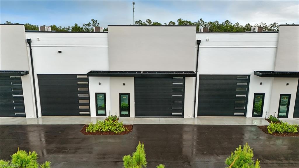 Modern commercial facade featuring a clean white and gray color palette