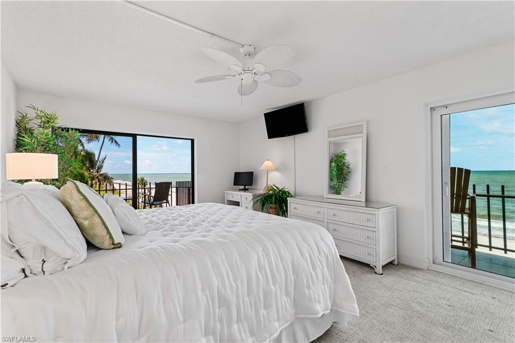 Bedroom featuring white walls and textured carpet flooring