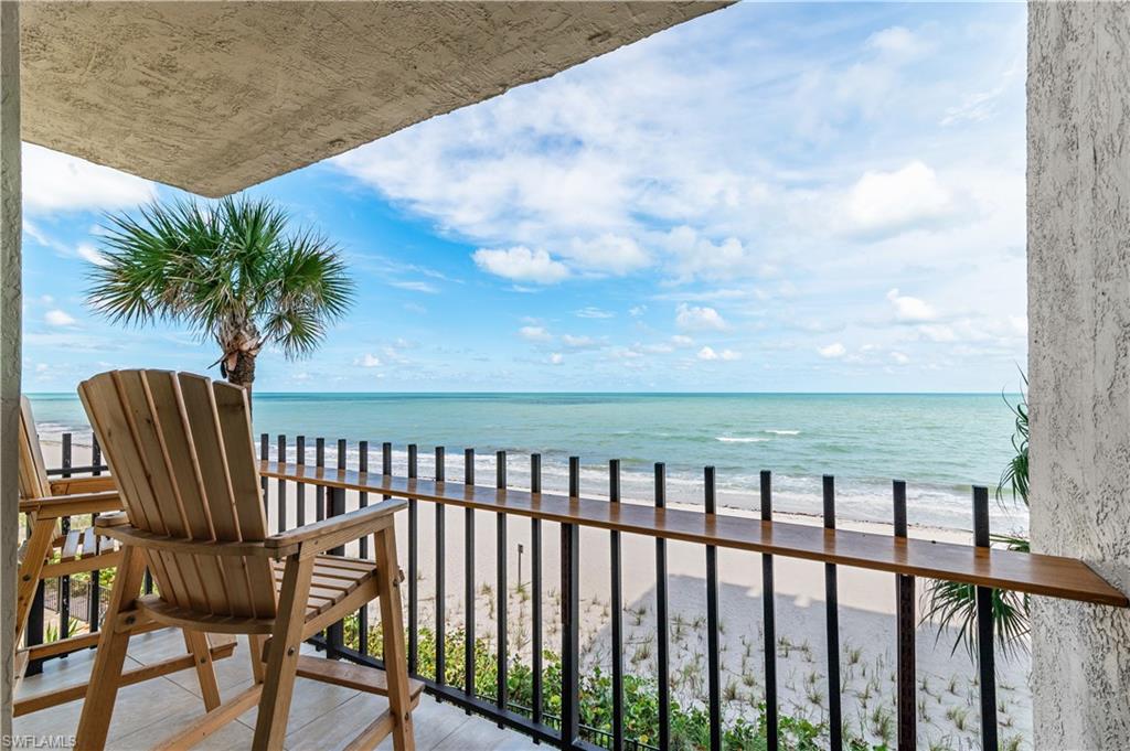Private balcony with direct ocean frontage, white sand beach, and clear blue water