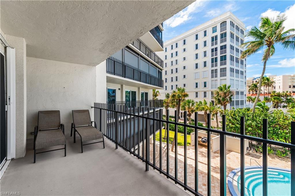 Private balcony with a concrete floor and black metal railing