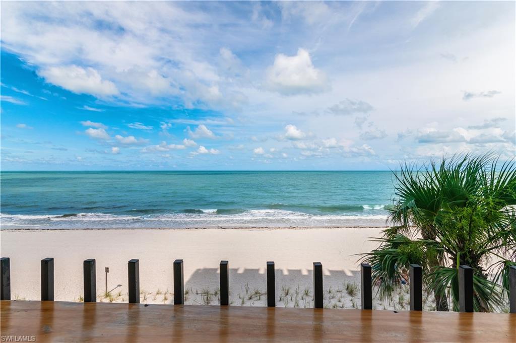 Expansive beachfront setting featuring white sand, tranquil turquoise waters, and a clear blue sky