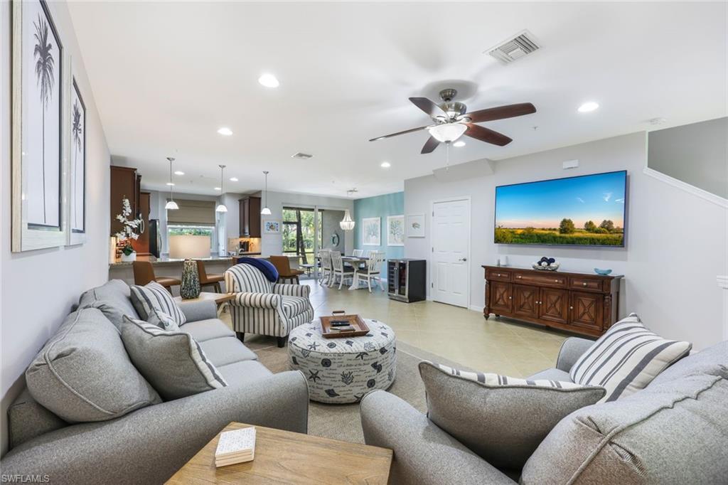 Tiled living room featuring ceiling fan