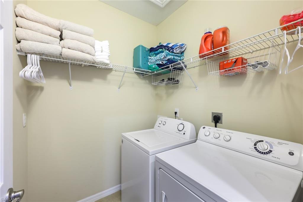 Clothes washing area featuring washing machine and dryer