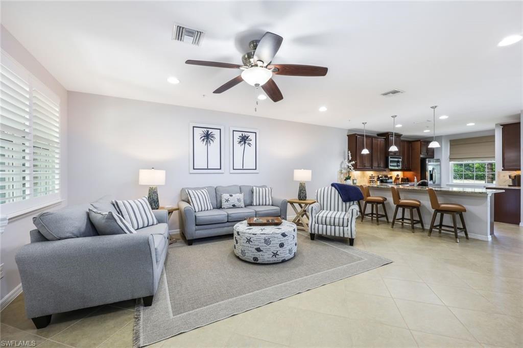 Tiled living room featuring ceiling fan