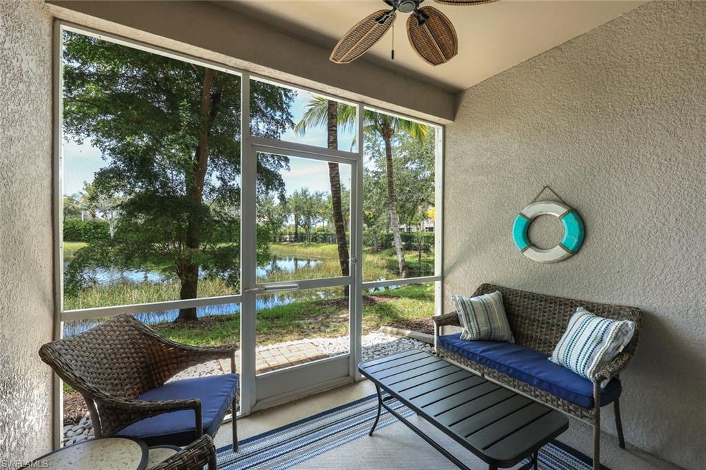 Sunroom featuring a water view, ceiling fan, and lofted ceiling