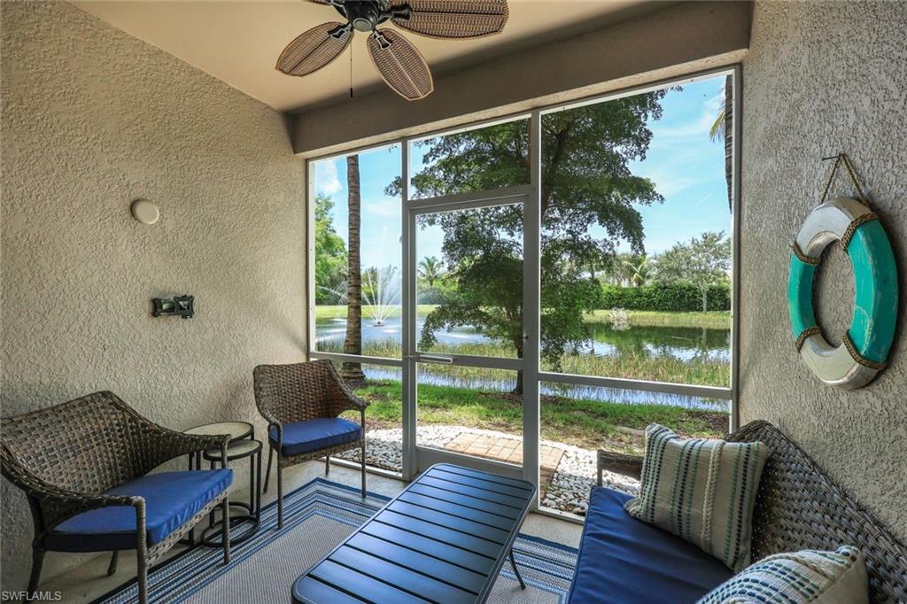 Sunroom featuring a water view and ceiling fan
