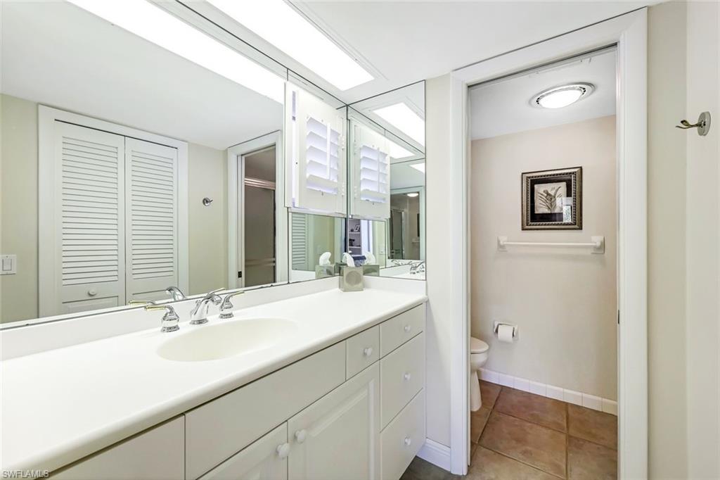Bathroom featuring vanity, toilet, and tile patterned flooring