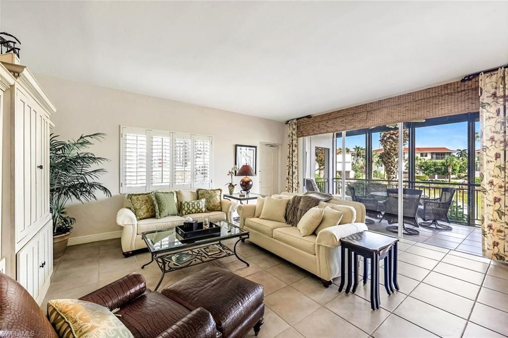 Tiled living room featuring plenty of natural light