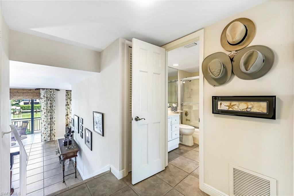 Hall featuring light tile patterned flooring